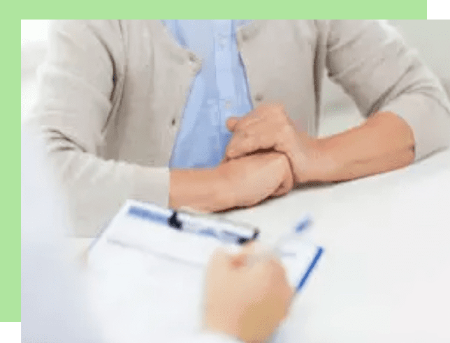 Patient consulting with a healthcare professional in a clinical setting.