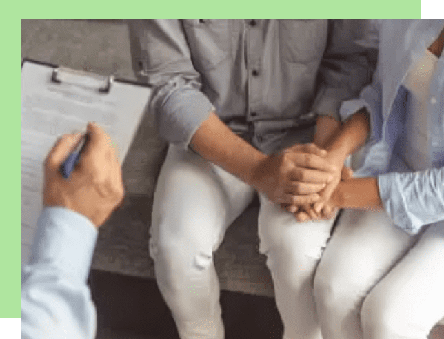Couple holding hands during a counseling session.