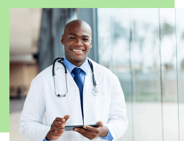 Smiling male doctor holding a tablet in a bright medical facility.