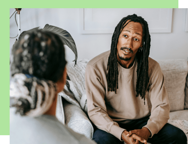Two people engaged in a thoughtful conversation indoors.